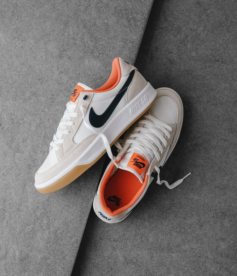 Nike SB Adversary Premium Shoes in White and Midnight Navy and Turf Orange
