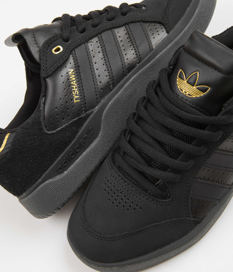 Adidas Tyshawn Low Shoes in Core Black and Core Black / Gold Metallic / Core Black