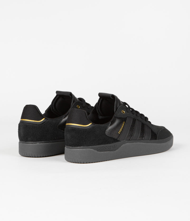 Adidas Tyshawn Low Shoes in Core Black and Core Black / Gold Metallic / Core Black