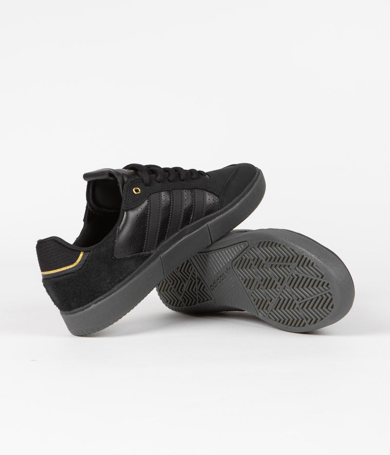 Adidas Tyshawn Low Shoes in Core Black and Core Black / Gold Metallic / Core Black