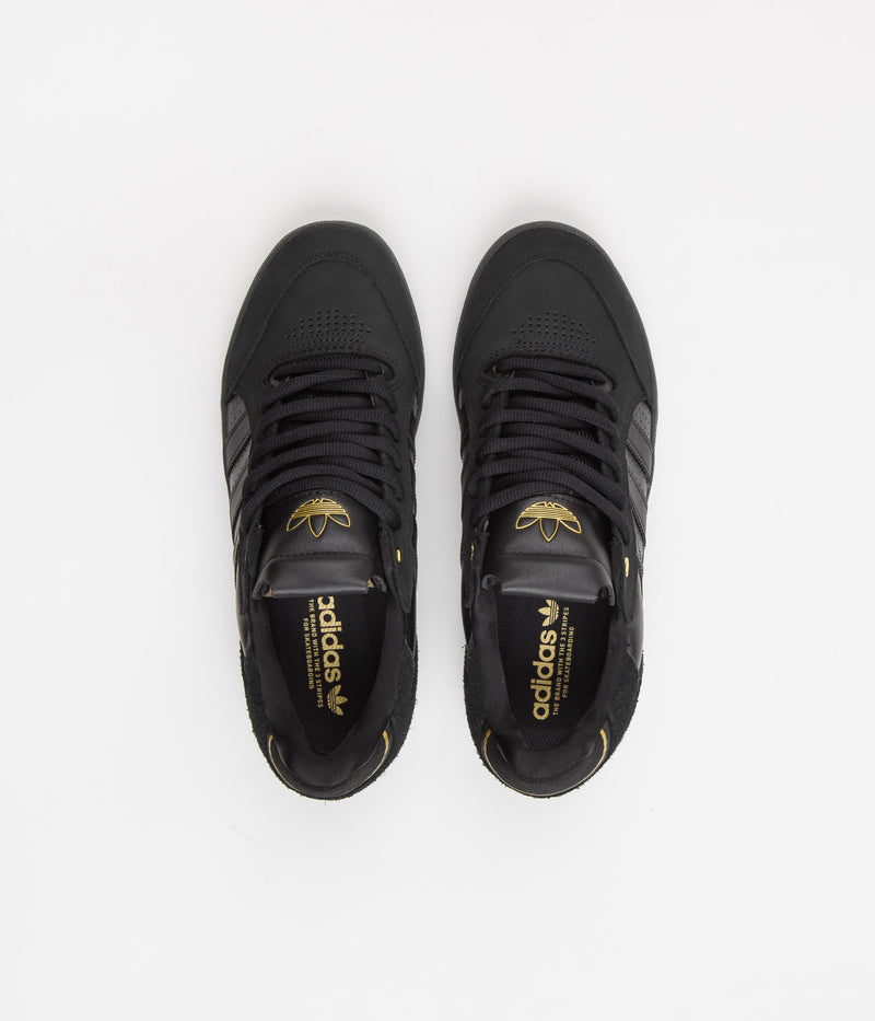 Adidas Tyshawn Low Shoes in Core Black and Core Black / Gold Metallic / Core Black